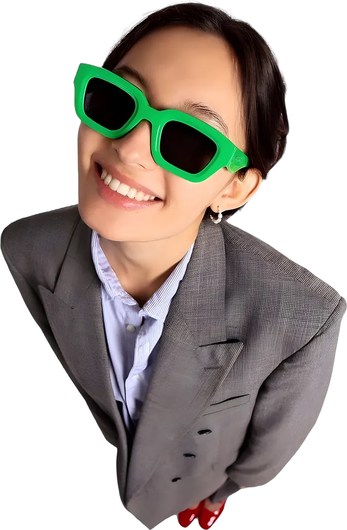 Smiling woman in green sunglasses and a grey blazer