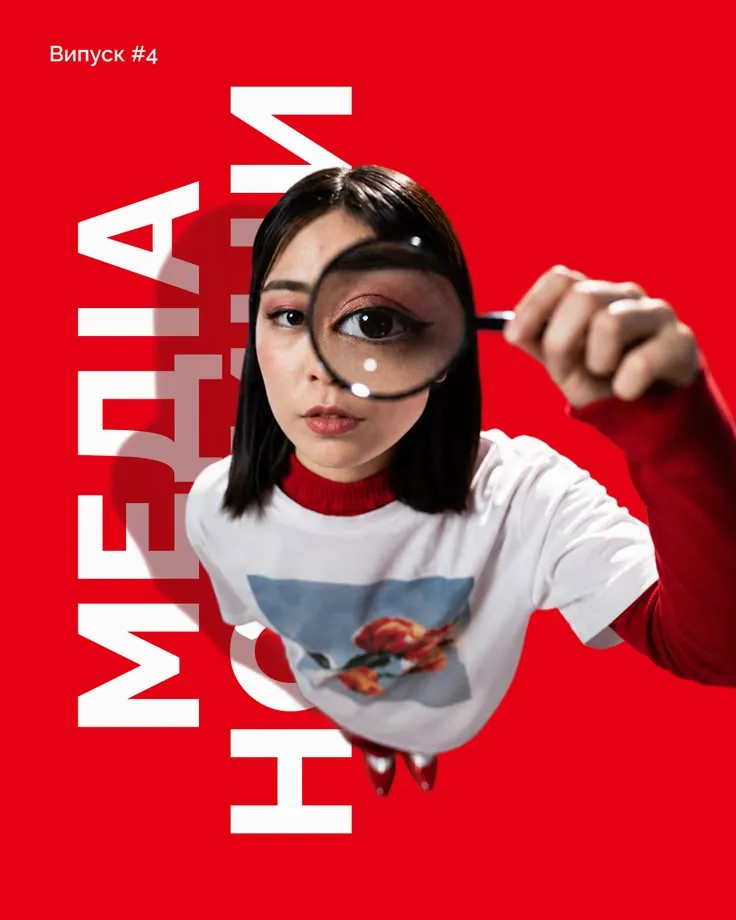 Woman looking through a magnifying glass