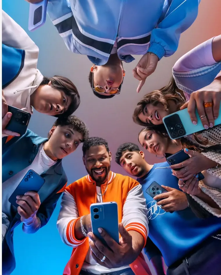 Group of friends looking down at their phones together